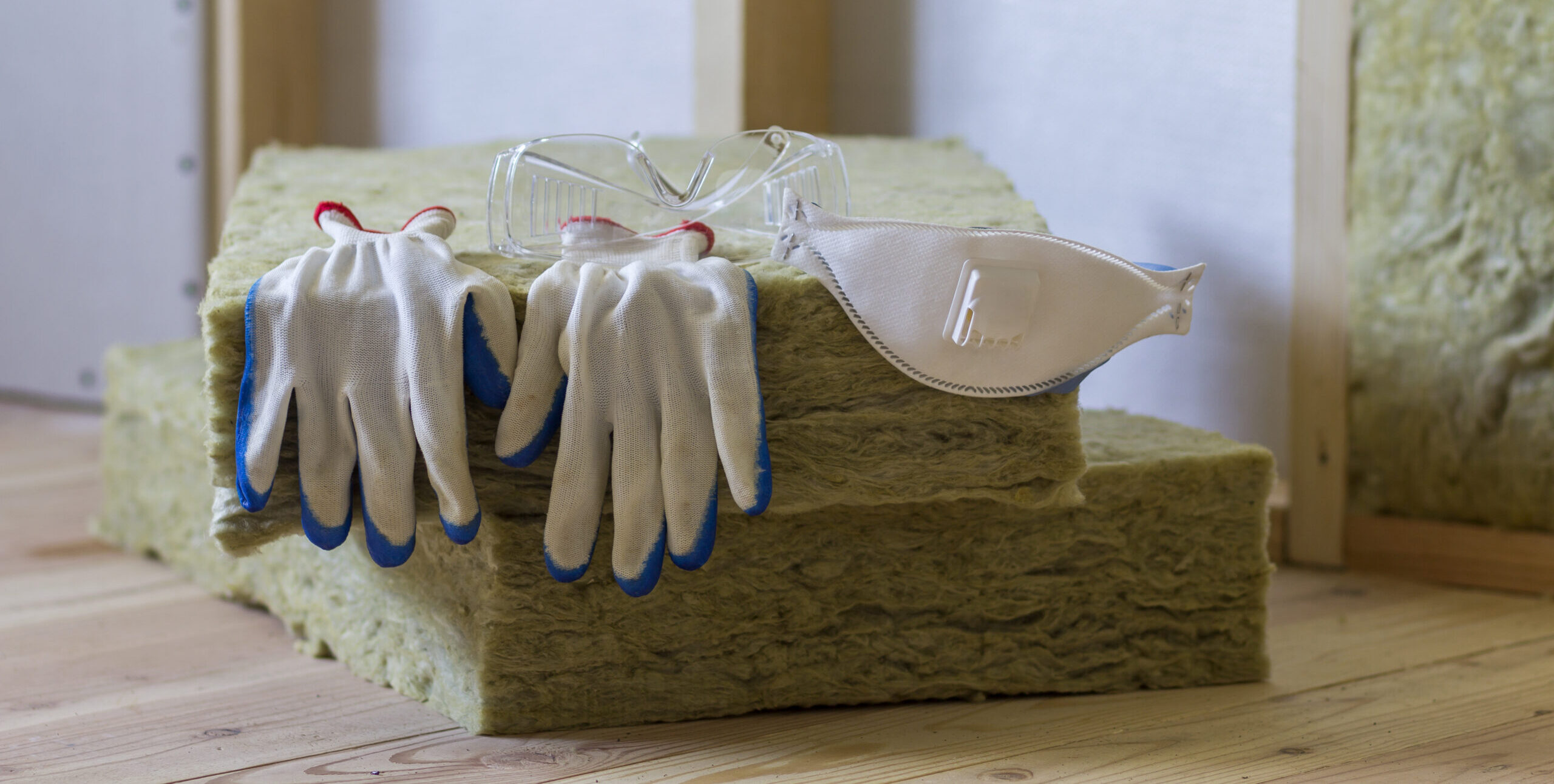 Isoliermaterial aus Steinwolle und Glasfaser für die Kältebarriere. Werkzeuge für die Arbeit mit Glaswolle